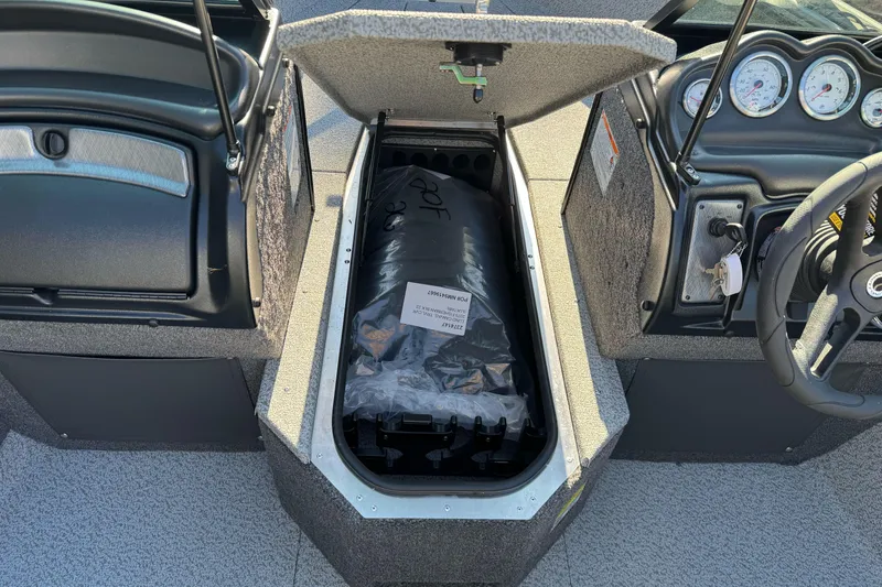 Slide: The Image of 2026 Lund 2075 Fisherman boat interior with open storage compartment and dashboard view. - 23