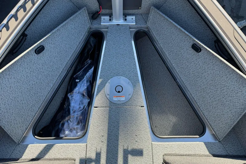 Slide: The Image of 2026 Lund 2075 Fisherman boat interior with open storage compartments. - 24