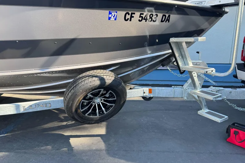 Slide: The Image of 2026 Lund 2075 Fisherman boat on trailer, featuring sleek design and durable construction. - 25