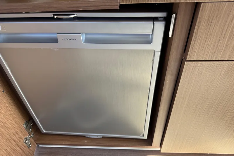 Slide: The Image of Compact Dometic fridge in 2021 Beneteau Antares 9 boat interior. - 14