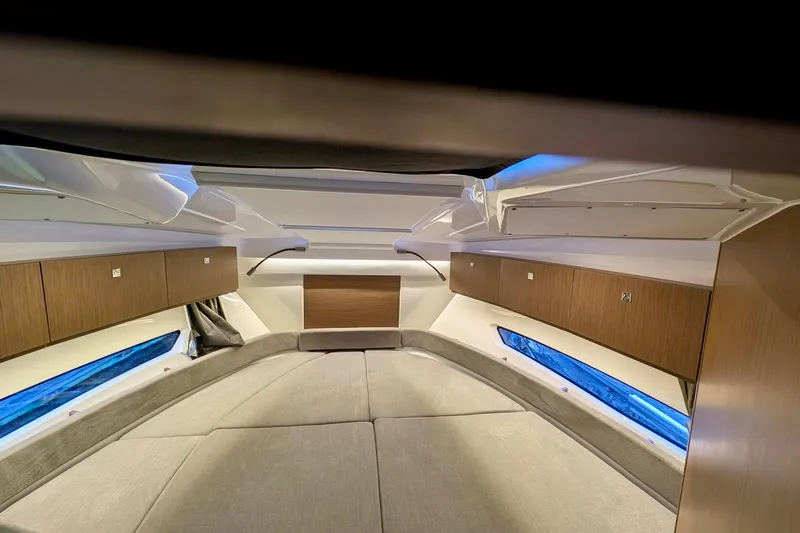 Slide: The Image of Interior cabin of 2021 Beneteau Antares 9, featuring modern wood cabinetry and cozy seating. - 19