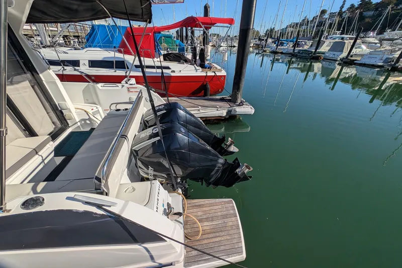 Slide: The Image of 2021 Beneteau Antares 9 docked at marina with dual outboard engines. - 2