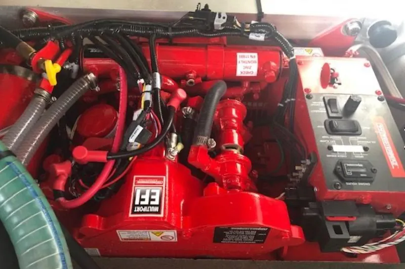 Slide: The Image of Engine compartment of a 2021 Beneteau Antares 9, featuring red mechanical components and wiring. - 21