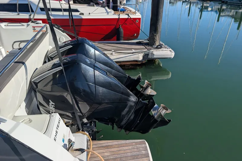Slide: The Image of Twin Mercury outboard engines on a 2021 Beneteau Antares 9 at a marina. - 3