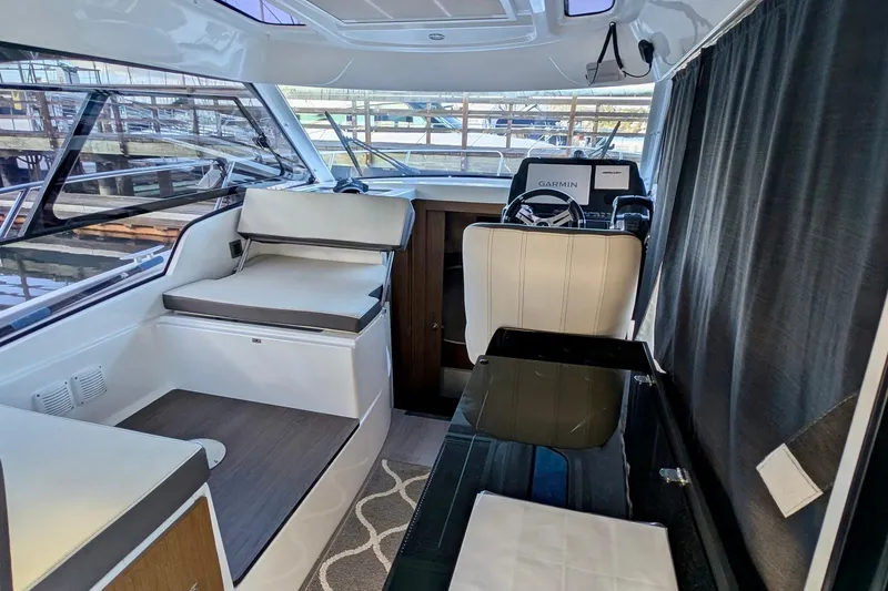 Slide: The Image of Interior of 2021 Beneteau Antares 9 boat with seating and navigation equipment. - 4