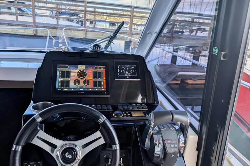 Slide: The Image of Cockpit view of 2021 Beneteau Antares 9 with modern navigation system and controls. - 7