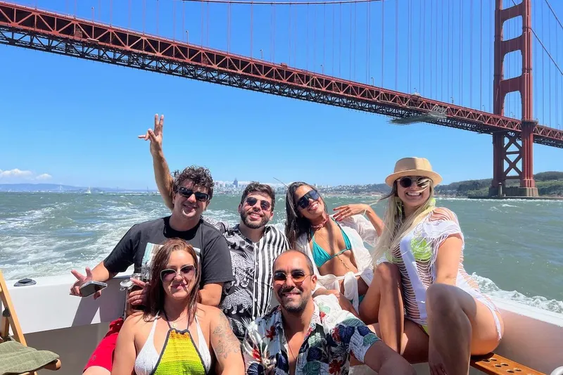 Slide: The Image of Group enjoying a boat ride on a 1999 Mainship Pilot 30 under the Golden Gate Bridge. - 11