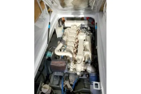 Slide: The Image of Engine compartment of a 1999 Mainship Pilot 30 boat, showcasing the engine and components. - 15