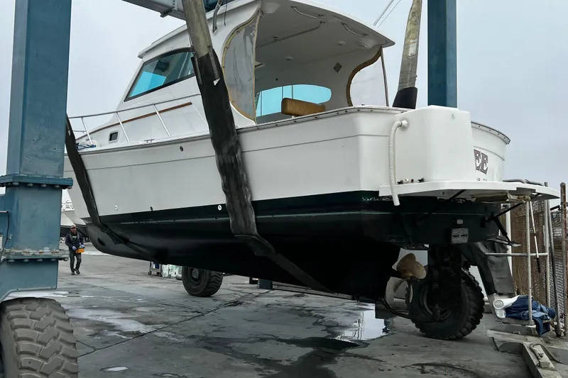 Slide: The Image of 1999 Mainship Pilot 30 boat lifted for maintenance at a marina. - 27