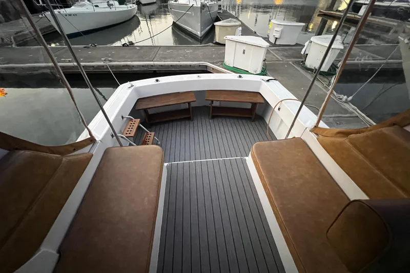 Slide: The Image of 1999 Mainship Pilot 30 boat deck with seating, docked at marina. - 5