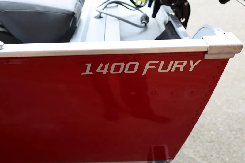 Slide: The Image of Red 2026 Lund 1400 Fury Tiller boat with visible model name on the side. - 10