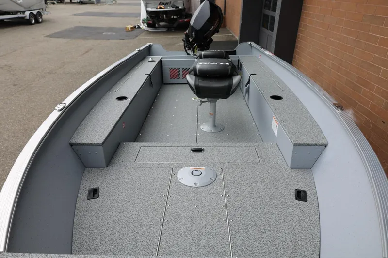 Slide: The Image of 2026 Lund 1400 Fury Tiller boat interior with seating and storage compartments. - 5