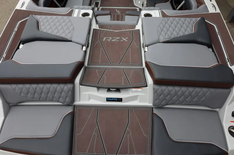 Slide: The Image of 2026 Tigé 22RZX boat interior with luxurious gray and brown seating and RZX branding. - 11