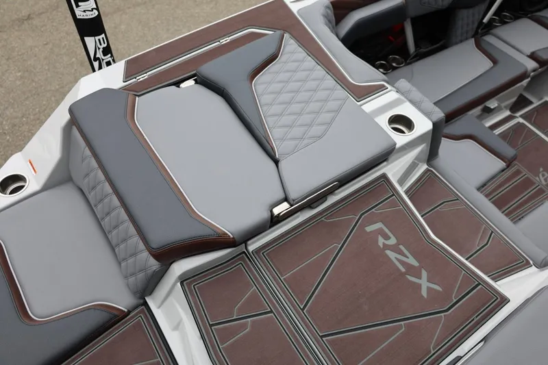 Slide: The Image of 2026 Tigé 22RZX boat interior with stylish gray and brown seating and RZX branding. - 12
