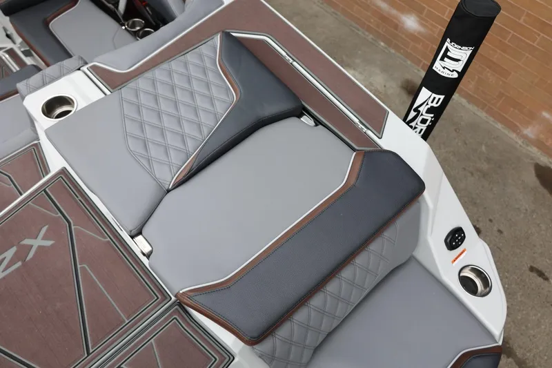 Slide: The Image of 2026 Tigé 22RZX boat interior with diamond-stitched upholstery and cup holders. - 13