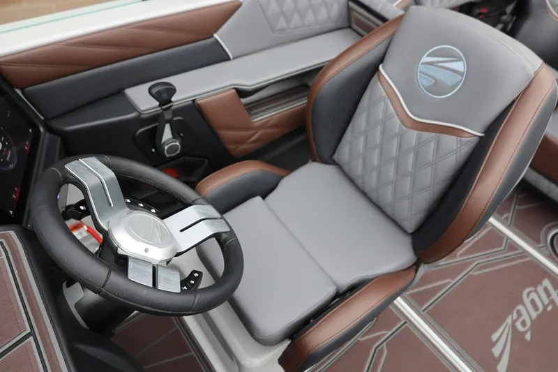Slide: The Image of 2026 Tigé 22RZX boat interior with luxury steering wheel and seat design. - 25