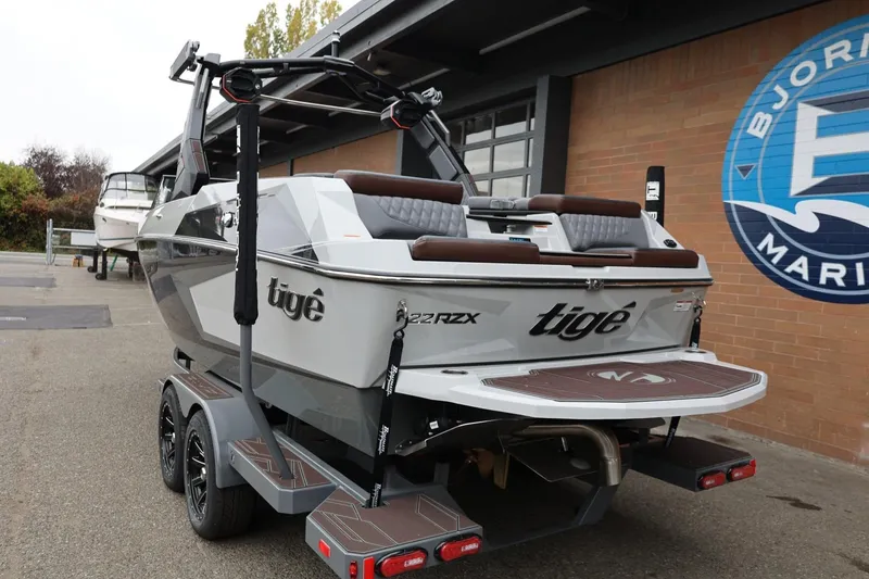 Slide: The Image of 2026 Tigé 22RZX boat on trailer at Bjornson Marine dealership. - 3