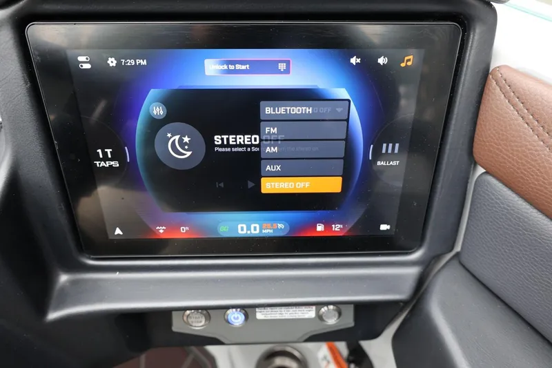 Slide: The Image of Touchscreen display in a 2026 Tigé 22RZX boat showing audio and ballast controls. - 32