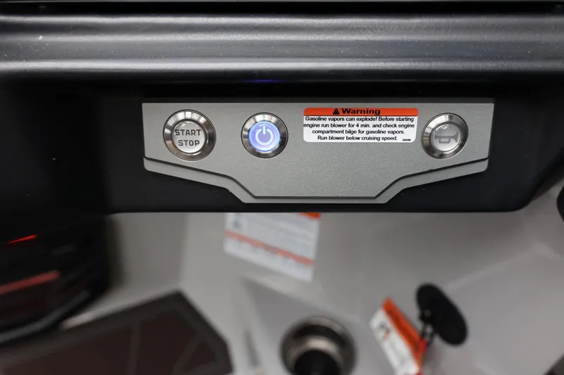 Slide: The Image of Control panel of 2026 Tigé 22RZX boat with start/stop button and warning label. - 37