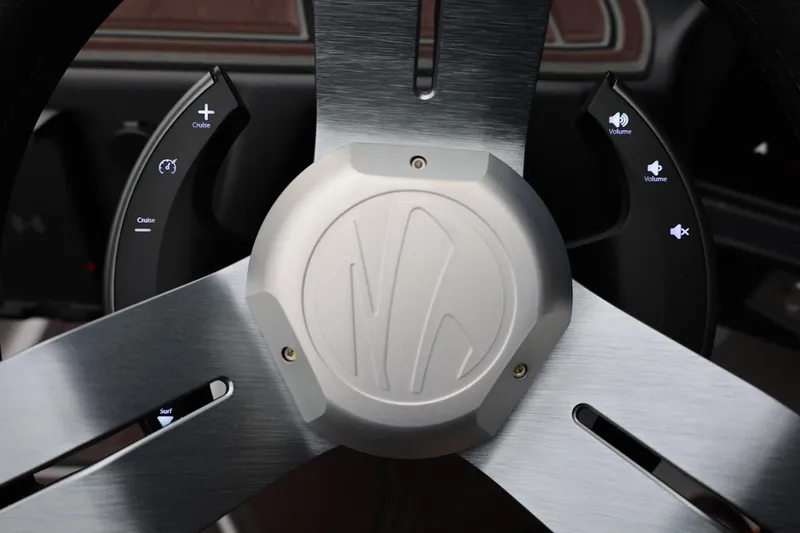 Slide: The Image of Steering wheel of 2026 Tigé 22RZX boat with cruise and volume controls. - 38