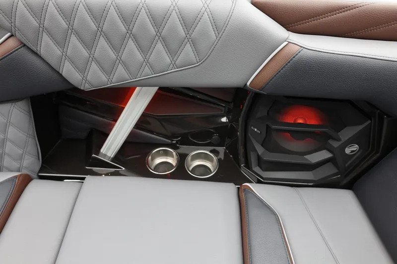 Slide: The Image of 2026 Tigé 22RZX interior with diamond-stitched upholstery, cup holders, and illuminated speaker. - 39