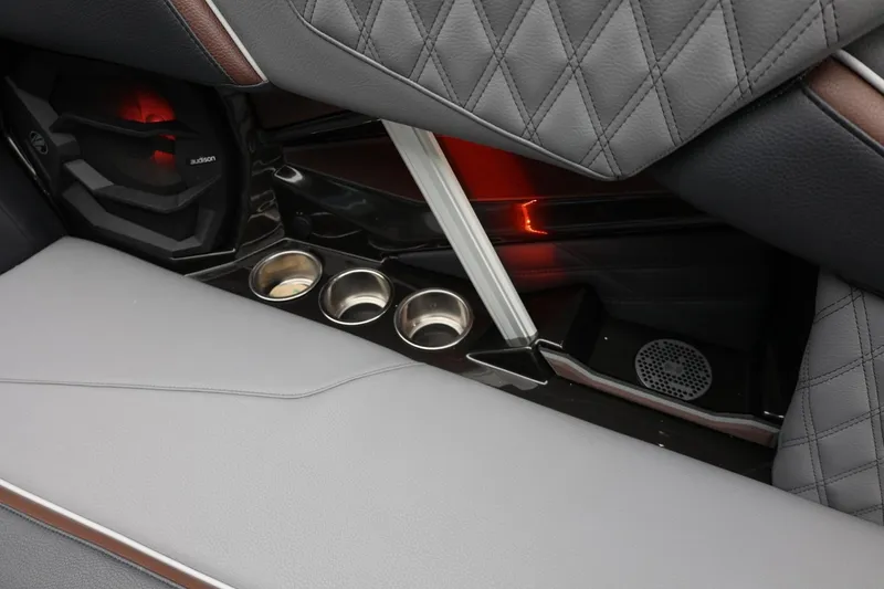 Slide: The Image of 2026 Tigé 22RZX interior with quilted seats, cup holders, and speaker system. - 40