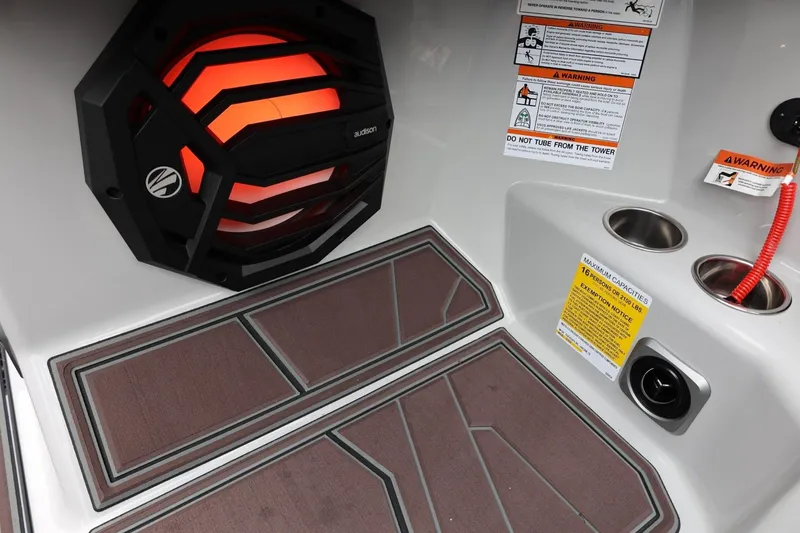 Slide: The Image of 2026 Tigé 22RZX boat interior with speaker, cup holders, and safety warnings. - 43