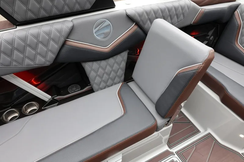 Slide: The Image of 2026 Tigé 22RZX interior with luxurious gray and brown seating, diamond stitching, and ambient lighting. - 46