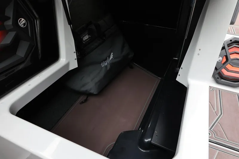 Slide: The Image of 2026 Tigé 22RZX boat storage compartment with speaker and branded bag. - 47