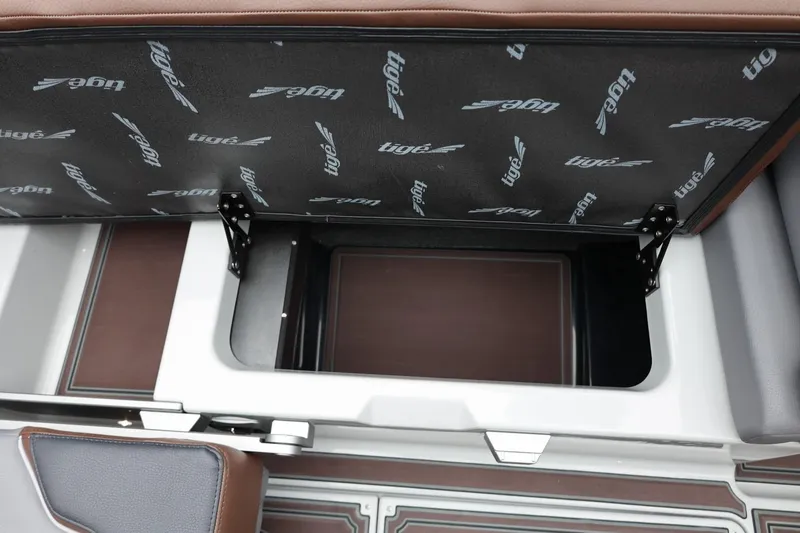 Slide: The Image of Open storage compartment in 2026 Tigé 22RZX boat with branded interior lining. - 48