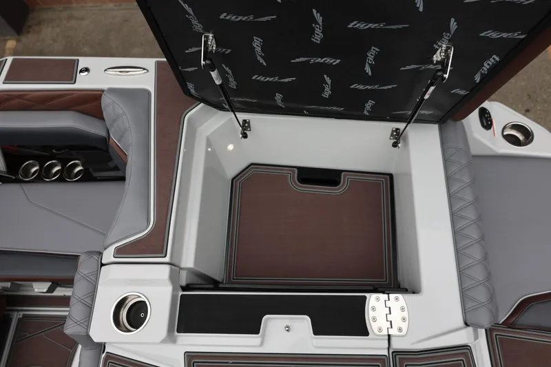 Slide: The Image of 2026 Tigé 22RZX boat interior storage compartment with stylish upholstery and cup holders. - 52