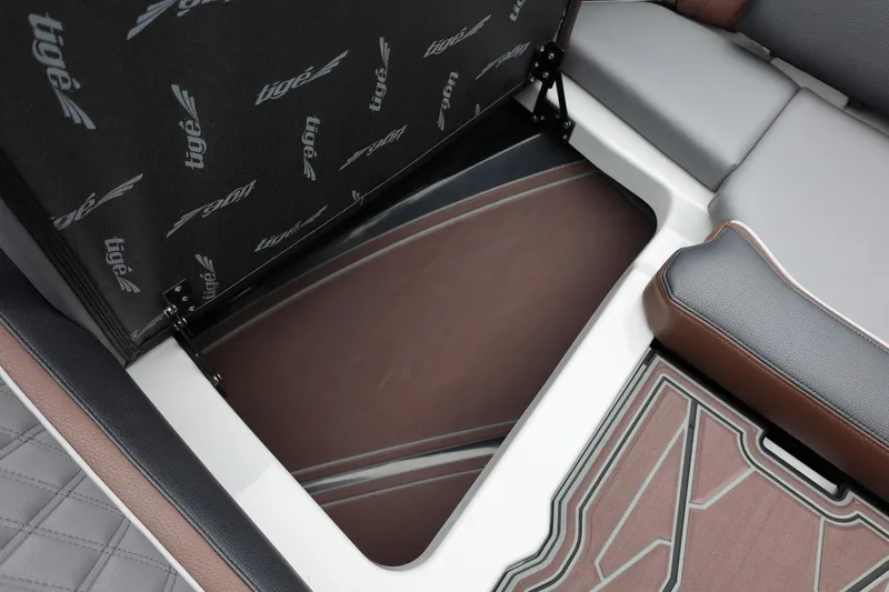 Slide: The Image of 2026 Tigé 22RZX boat interior storage compartment with stylish seating and flooring. - 56
