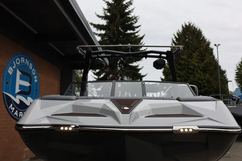 Slide: The Image of 2026 Tigé 22RZX boat at Bjornson Marine dealership, front view with sleek design. - 6