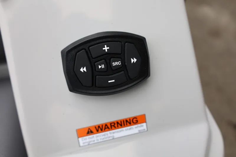 Slide: The Image of 2026 Tigé 22RZX boat control panel with audio buttons and warning label. - 61