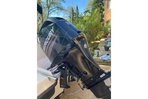 Slide: The Image of 2013 Bayliner 170 Bowrider with Mercury outboard motor in a sunny outdoor setting. - 4