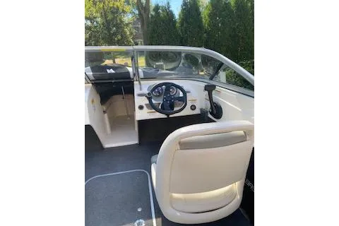 Slide: The Image of 2013 Bayliner 170 Bowrider interior with steering wheel and seating. - 6