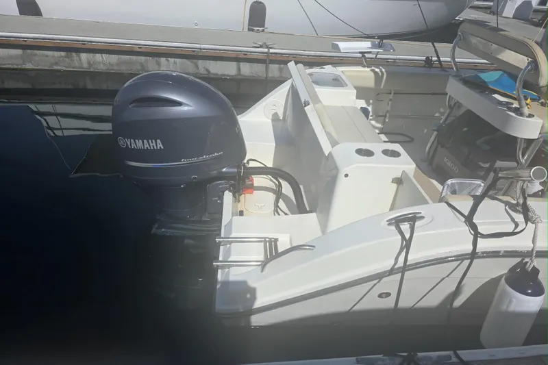 Slide: The Image of 2017 Cobia T-Top boat with Yamaha outboard motor docked at marina. - 7
