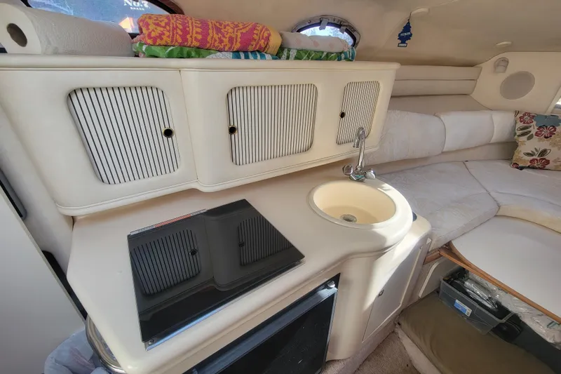 Slide: The Image of Interior of 2000 Sea Ray 260 Sundancer with kitchenette and seating area. - 13