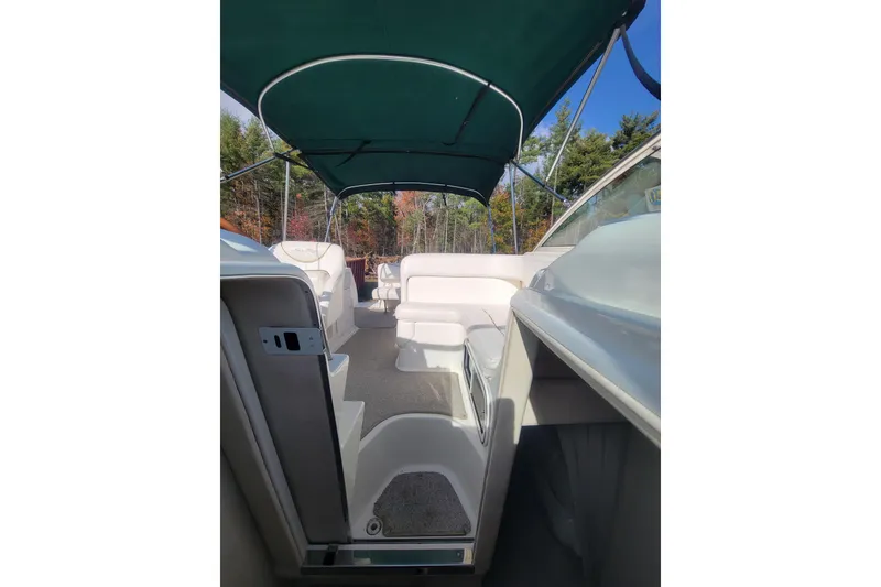 Slide: The Image of Interior view of 2000 Sea Ray 260 Sundancer boat with green canopy and white seating. - 14