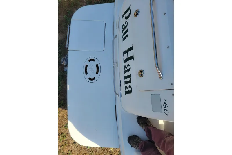 Slide: The Image of 2000 Sea Ray 260 Sundancer boat deck with "Pau Hana" name visible. - 15