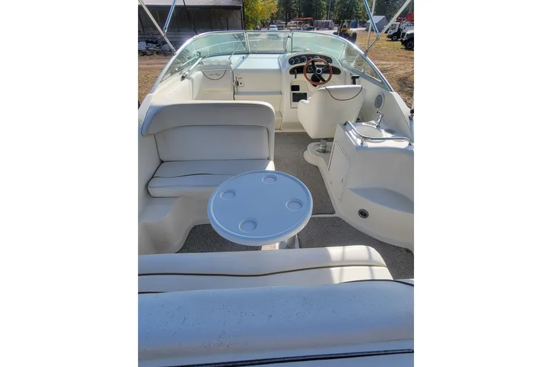 Slide: The Image of Interior view of a 2000 Sea Ray 260 Sundancer boat with seating and steering area. - 2