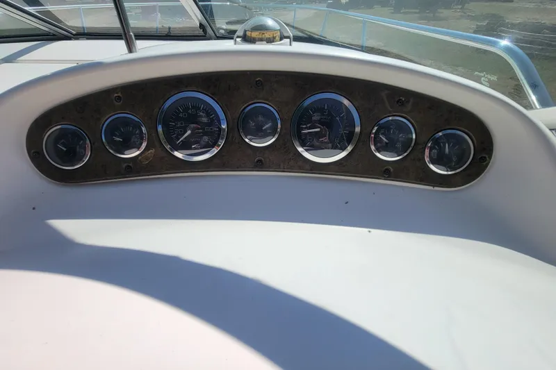 Slide: The Image of Dashboard of 2000 Sea Ray 260 Sundancer boat with multiple gauges. - 26