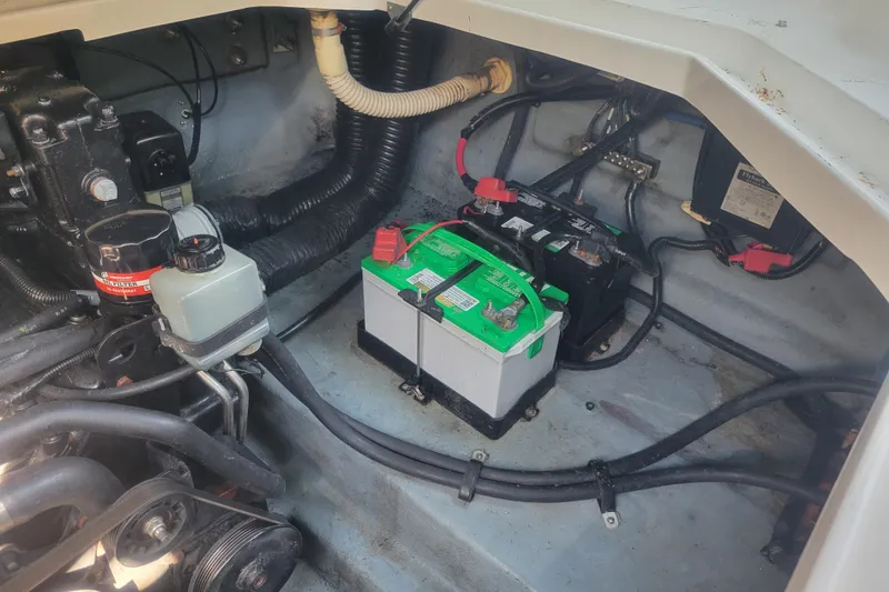 Slide: The Image of Engine compartment of a 2000 Sea Ray 260 Sundancer with visible battery and wiring. - 29