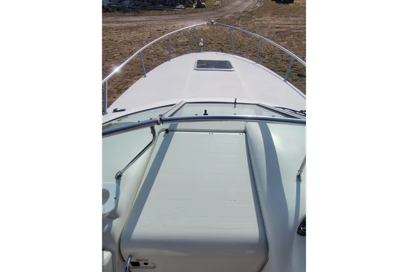 Slide: The Image of 2000 Sea Ray 260 Sundancer boat deck with railing, viewed from above. - 3