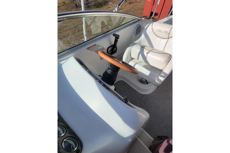 Slide: The Image of Interior view of 2000 Sea Ray 260 Sundancer boat cockpit with steering wheel. - 4