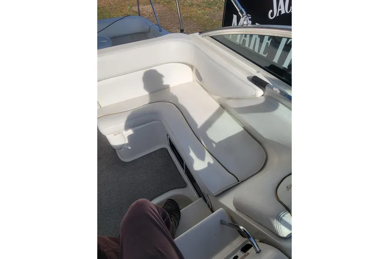 Slide: The Image of 2000 Sea Ray 260 Sundancer interior with white seating and shadow. - 5