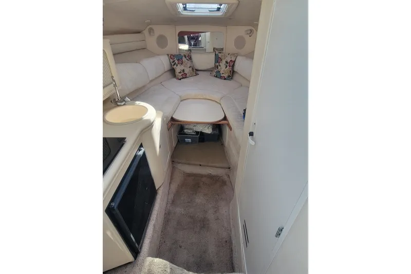 Slide: The Image of Interior of 2000 Sea Ray 260 Sundancer boat with cozy seating and compact amenities. - 7
