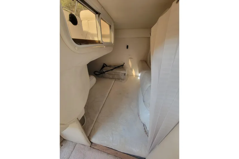 Slide: The Image of Interior cabin of 2000 Sea Ray 260 Sundancer boat, featuring seating and windows. - 9