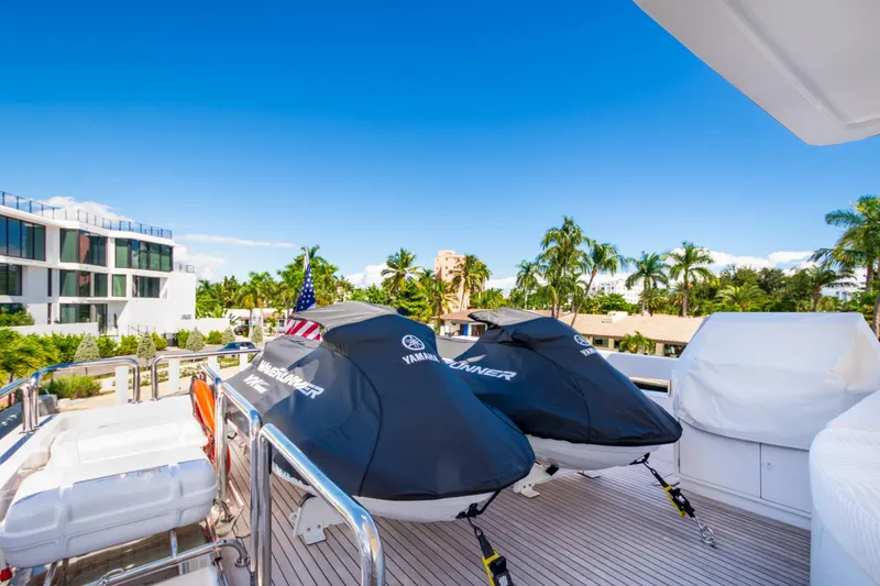 Slide: The Image of Luxury 2006 Hargrave Raised Pilothouse yacht deck with jet skis, palm trees, and clear blue sky. - 16