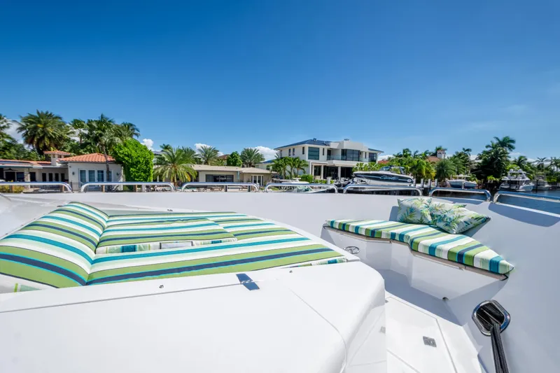 Slide: The Image of Luxurious 2006 Hargrave Raised Pilothouse yacht with striped sun loungers, docked near waterfront homes. - 18